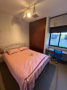a bedroom with a bed and a chair and a window at Comfort Home For You in Perth
