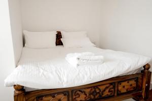 a bed with white towels on top of it at Serenity heights cosy 2BHK in Jāmb