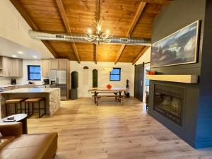 a living room with a fireplace and a table at Cozy Creekside cabin- 35m to Boone in Butler