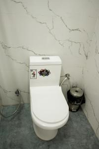 a bathroom with a white toilet in a room at Serenity heights cosy 2BHK in Jāmb +16 photos