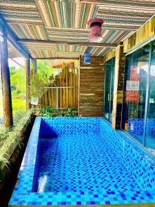 a swimming pool in a house with blue tiles at Sky View hostel in Sapa
