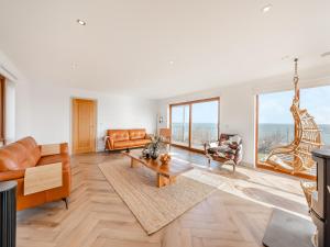 a living room with a couch and a table at The Beaches in Berwick-Upon-Tweed