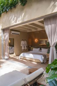 a large bedroom with two beds in a room at Arde La Selva in Santa Fe de Antioquia