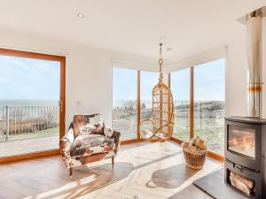 a living room with a chair and a fireplace at The Beaches in Berwick-Upon-Tweed