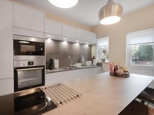 a kitchen with a counter top with a stove top oven at Beaconsfield House in Mundesley