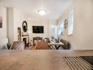 a dining room and living room with a table and chairs at Beaconsfield House in Mundesley +23 photos