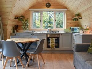 a kitchen with a table and a table and chairs at Lakeview Lodge- Uk40692 in Crowhurst