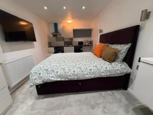 a bed in a small room with a kitchen at WBC R4 - Private Studio Room in Bilston +7 photos