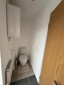 a small bathroom with a toilet and a cabinet at WBC R4 - Private Studio Room in Bilston