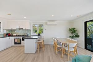 a kitchen and dining room with a table and chairs at Misty Haven at Wentworth Falls in Wentworth Falls