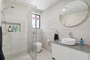 a bathroom with a shower and a toilet and a sink at Misty Haven at Wentworth Falls in Wentworth Falls +25 photos