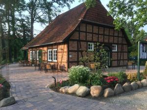 a house with a tiled roof and a patio at Holiday apartment with 1 bedroom in Nindorf