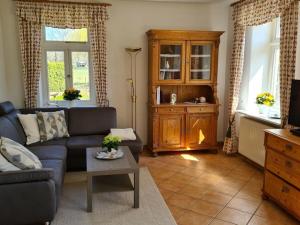 a living room with a couch and a table at Holiday apartment with 1 bedroom in Nindorf