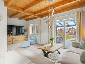 a living room with a couch and a table at Holiday apartment with 2 bedrooms in Timmel