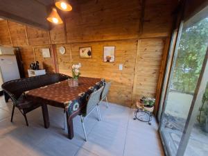 a dining room with a table and chairs at Casa reformada perto CMPC in Guaíba +17 photos