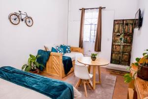 a living room with a bed and a table at Private Studio, Very Centric and Flexible Check-In in Antigua Guatemala