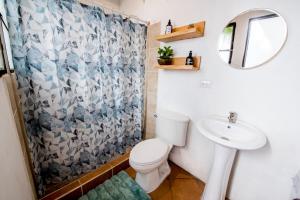 a bathroom with a toilet and a sink and a mirror at Private Studio, Very Centric and Flexible Check-In in Antigua Guatemala +15 photos