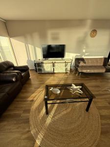 a living room with a couch and a coffee table at San Alfonso del Mar 7P in Algarrobo