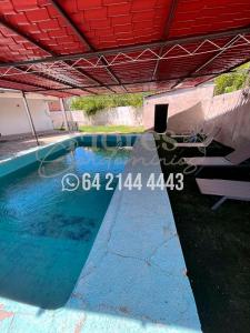 a swimming pool with blue water in a building at Flores Condominios Casa Narciso in Álamos