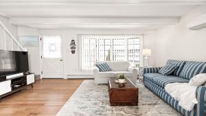 a living room with a couch and a tv at Lagoon Front 4 Bedroom Beat The Crowds in Beach Haven West