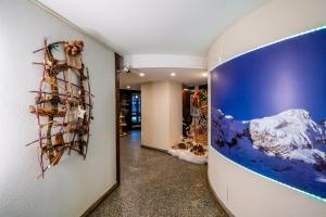 a hallway with a large painting on the wall at Cervinia Ski In Ski Out - Peak Studio in Breuil-Cervinia +1 photo