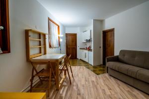 a living room with a couch and a table at Cervinia Ski In Ski Out - Peak Studio in Breuil-Cervinia