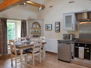a kitchen and dining room with a table and chairs at Brow View Cottage in Ravenstonedale