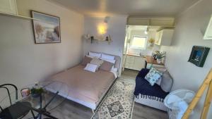 a small bedroom with a bed and a glass table at Kiama Dreams in Kiama
