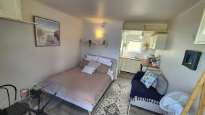 a small bedroom with a bed and a table at Kiama Dreams in Kiama
