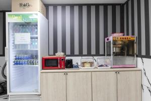 仁川にあるJuan 3&4 Hotelの赤い電子レンジが上に置かれた冷蔵庫