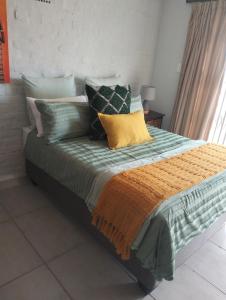 a bed with many pillows on it in a room at Mountain view in George
