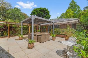 a patio with a gazebo and a table and chairs at Tamborine Mountain Lodge in Mount Tamborine