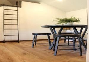 a table and two stools with a potted plant on it at Black Hills Glamping Cabin, Perfect for an Outdoor Adventure in Hill City