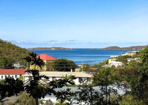 a view of a town with the ocean in the background at Oceanview Stay - Walk to Beach in Enighed