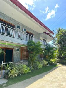 a building with a balcony and plants in front of it at Felicitas Guest House- Siargao in General Luna +7 photos