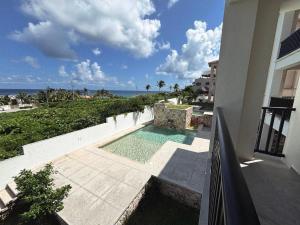 uitzicht op een zwembad vanaf een balkon van een gebouw bij Holiday apartment at La Diosa condos Isla Mujeres in Isla Mujeres