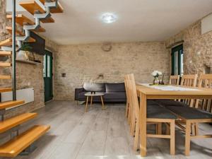 a living room with a table and a couch at Buljanovi Dvori with private pool in Garci