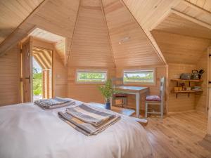 a bedroom with a bed with towels on it at Dol Y Mynydd The Mountain Meadow - Cottage in Llangernyw