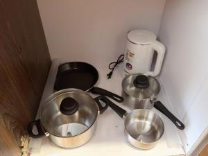 a kitchen counter with two pans and a coffee maker at Destiny Hotel - 1605 in Sampong