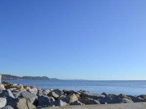 a group of rocks next to the water at The Pocker Watch in Chideock