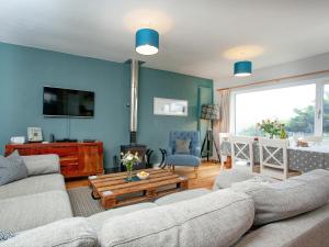 Una sala de estar con dos sofás y un televisor. en Semybadazee, en Poundstock