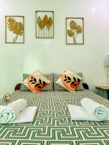 a bedroom with a bed with halloween pillows on it at Felicitas Guest House- Siargao in General Luna