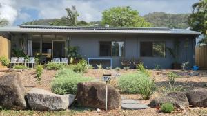a house with rocks in front of it at Stay on Sooning in Nelly Bay