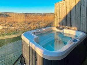 a hot tub on a deck with a view of the desert at 8 person holiday home in Vestervig-By Traum in Vestervig