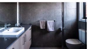 a bathroom with a sink and a toilet at The Robinson in Connewarre