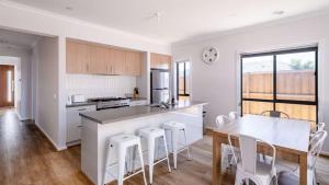a kitchen and dining room with a table and chairs at The Robinson in Connewarre