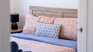 a bed with lots of pillows on it at The Robinson in Connewarre