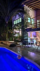 a house with a swimming pool at night at Toro by Dreamcatcher in Santa Teresa Beach +169 photos