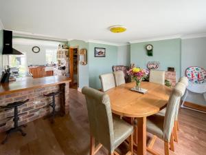 Una cocina y un comedor con mesa y sillas de madera. en Homestead, en Long Sutton