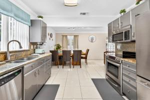 een keuken met roestvrijstalen apparatuur en een eetkamer bij The Flamingo*4bed*pool*jacuzzi*foosball in Valrico